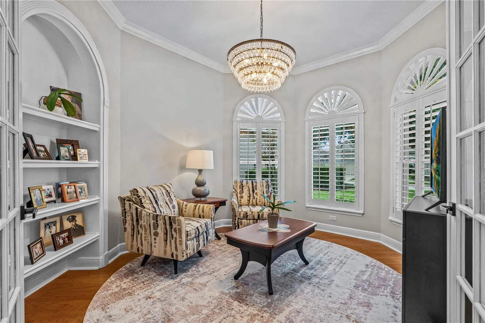 Currently used as a den, this would also make a great office with the built-in shelves; With all the windows, it's always light and bright