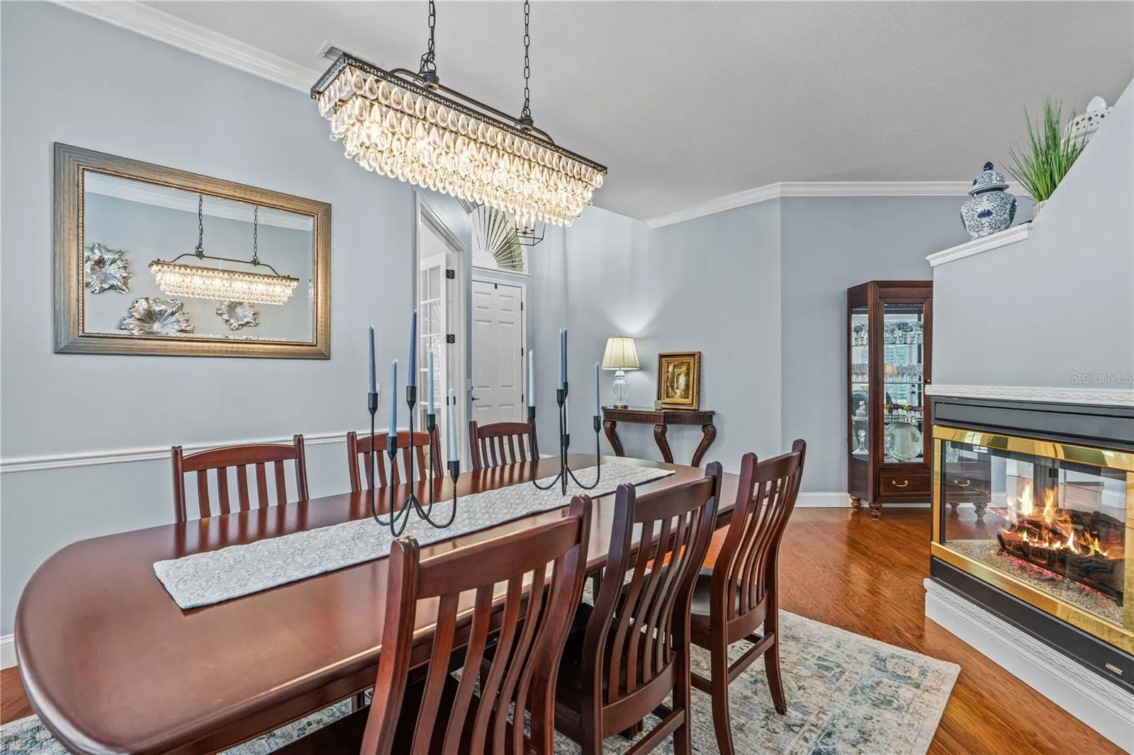 Gorgeous dining room light fixture coordinates with the chandelier in the den