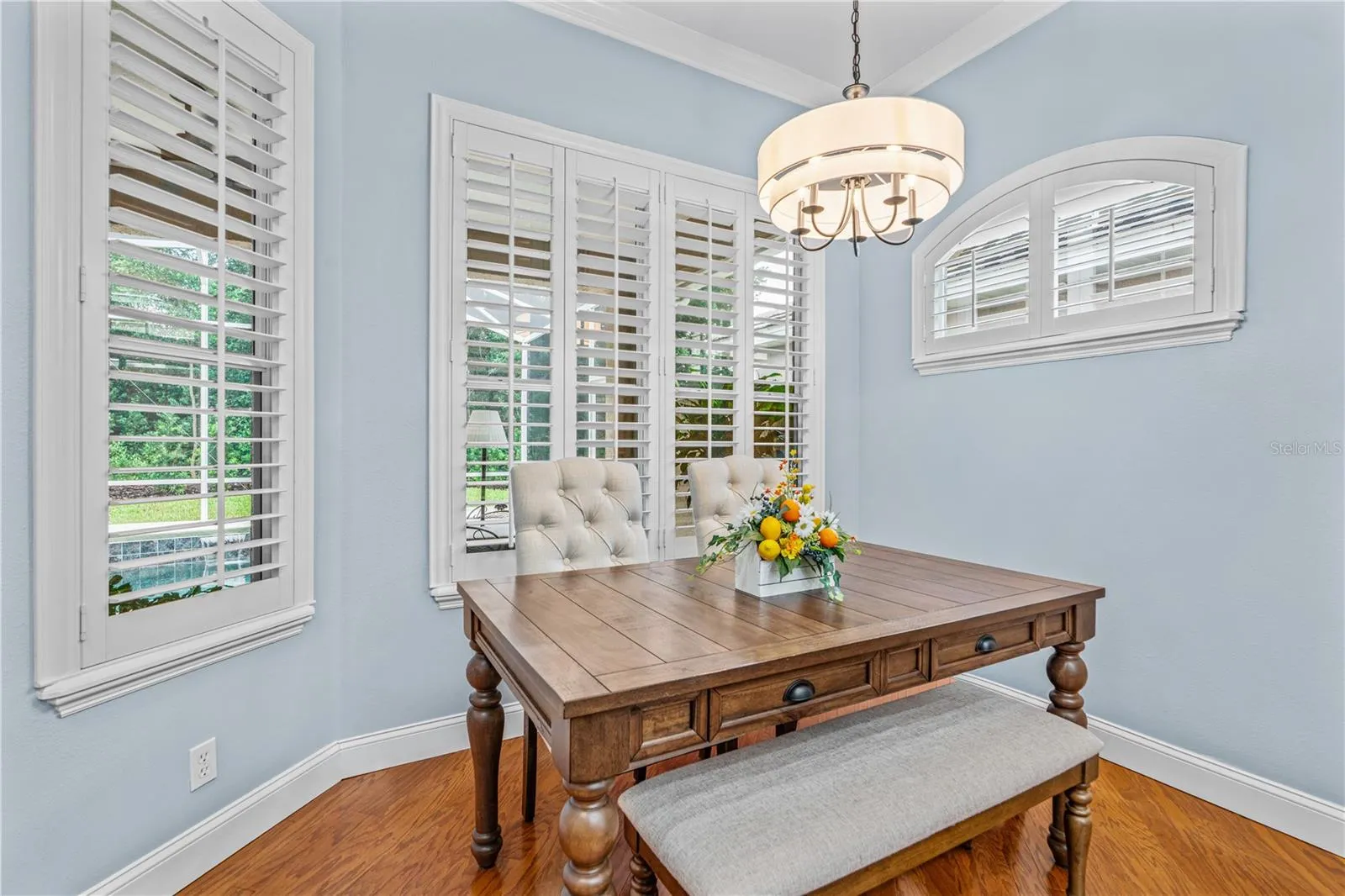 The eat-in kitchen offers large windows to enjoy the view out back toward the golf course