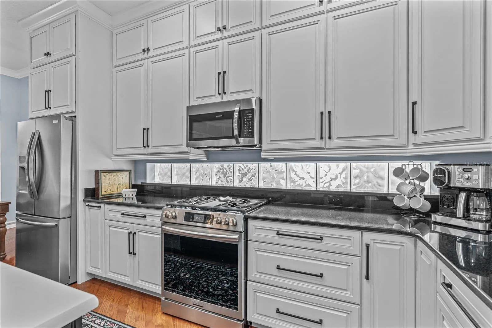 All the cabinets in the home are solid wood and custom made with soft close doors and drawers. The extra high cabinets take advantage of every inch of those 10ft ceilings and are great for storing seasonal items