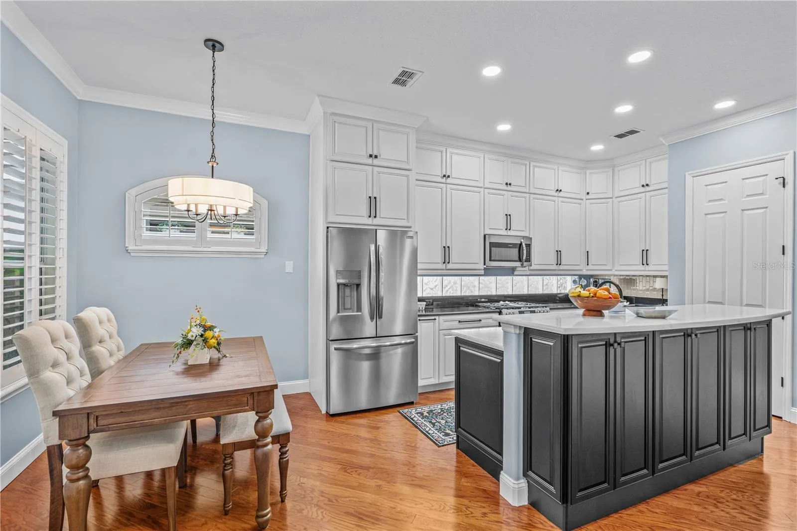 The renovated kitchen offers tons of storage-- there are even cabinets under the breakfast bar!