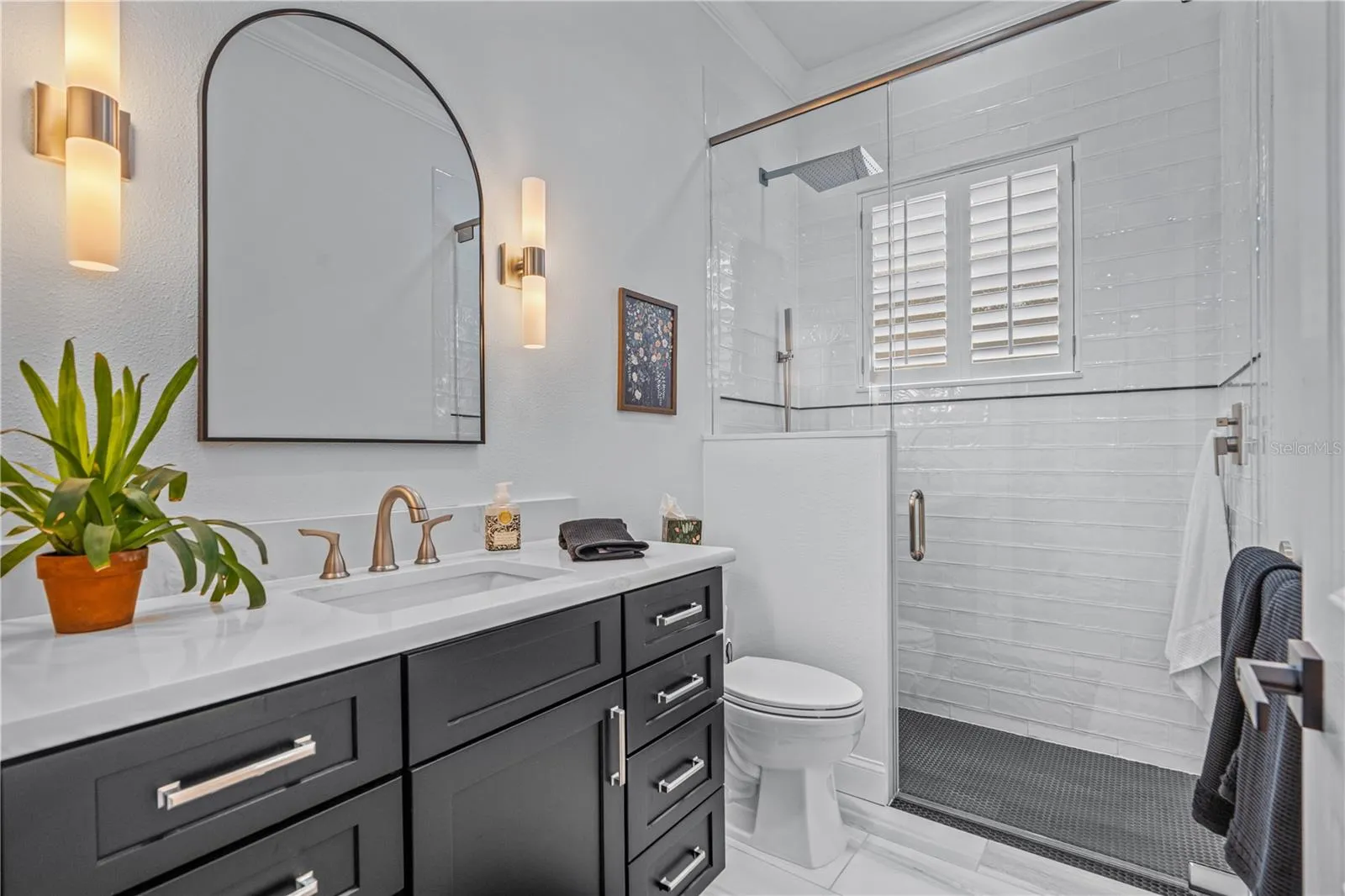 Renovated guest bathroom with walk-in/roll-in shower with no threshold for easy access