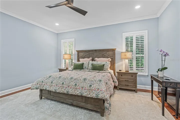 The primary bedroom windows overlook the back yard-- which is very private due to mature landscaping and trees
