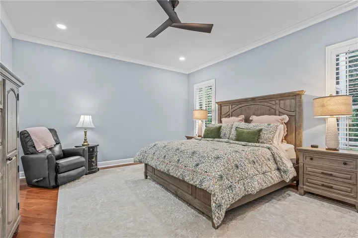 Hardwood floors extend to the primary bedroom; Additional can lights were added as well as an updated ceiling fan during the 2024 renovations