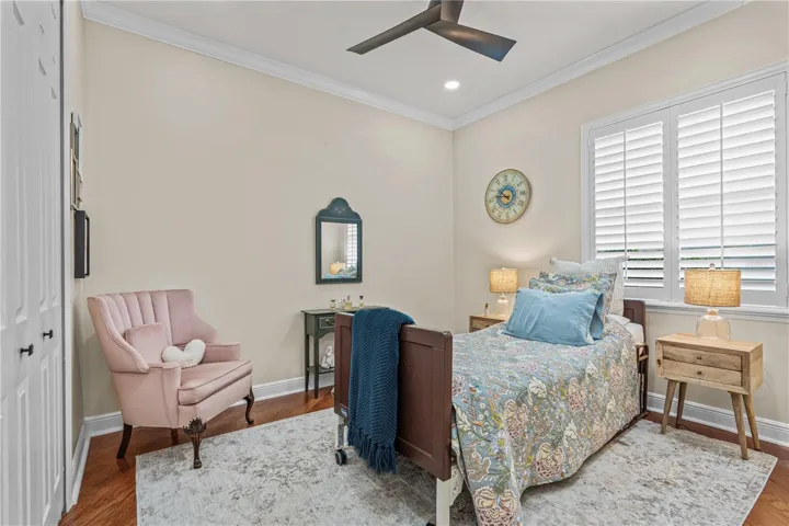 Bedroom 3 with hardwood floors, updated ceiling fan and extra can lights installed in the ceiling