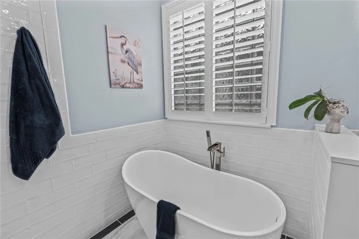 A relaxing soaker tub surrounded by elegant tile