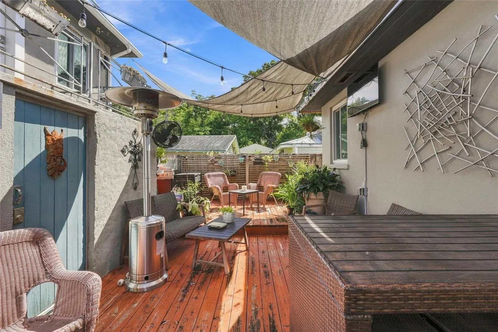 patio area with grill, plant potting station, tables and furnishings