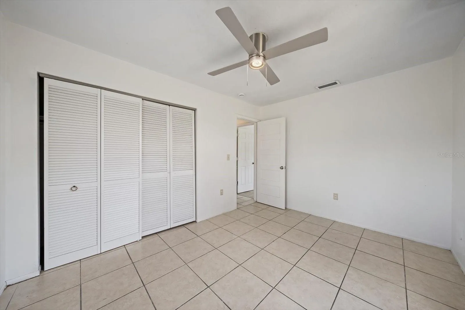 3rd bedroom- long closet, view towards hall (guest bathroom on left, 2nd bedroom on right)