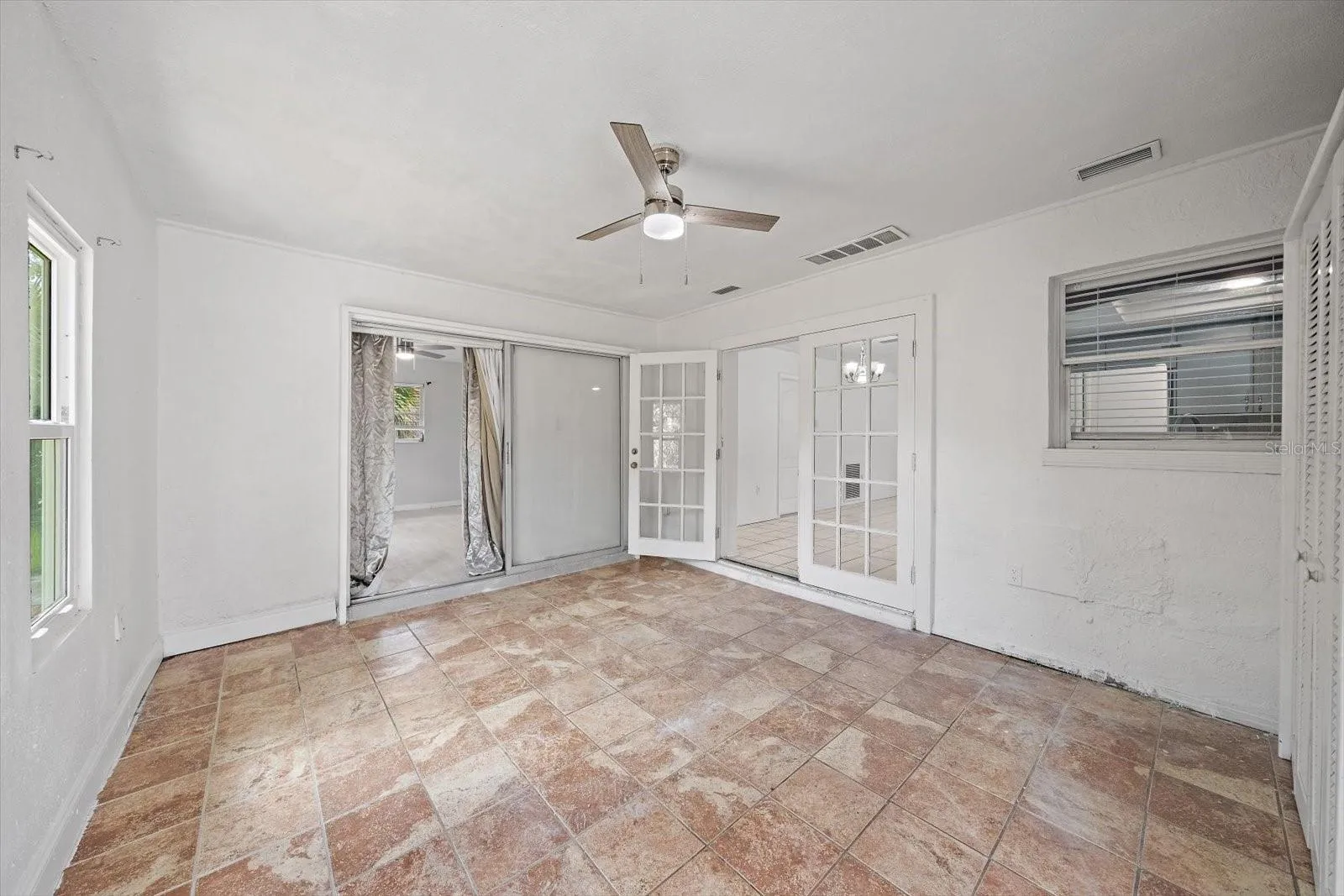 Slider to Primary (1st) bedroom, French doors to dining room, window to kitchen (sink)