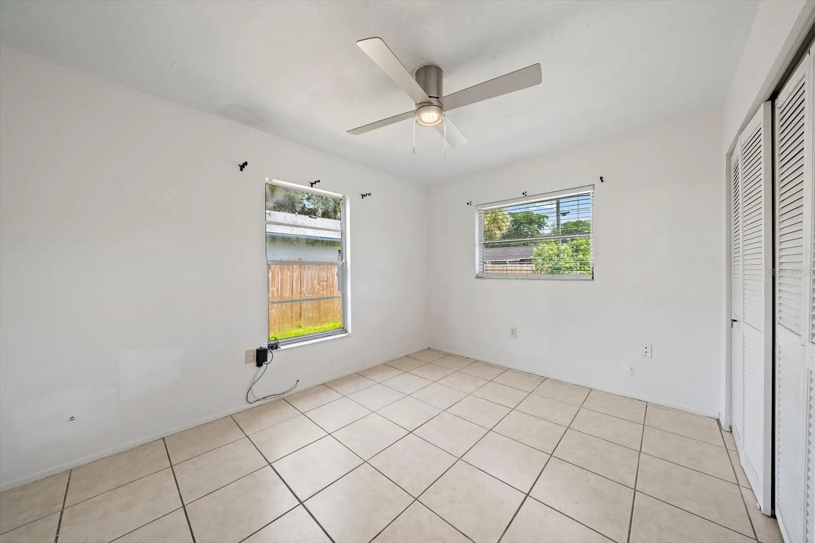 3rd bright bedroom, same tile and ceiling fan.