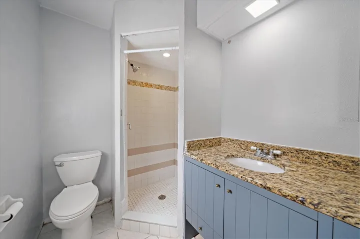 Primary bedroom Bathroom with step-in shower and there is a window which provides good light