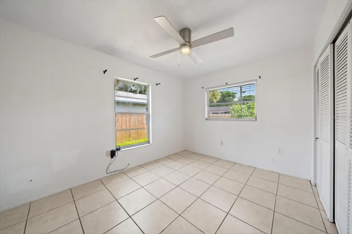 3rd bright bedroom, same tile and ceiling fan.