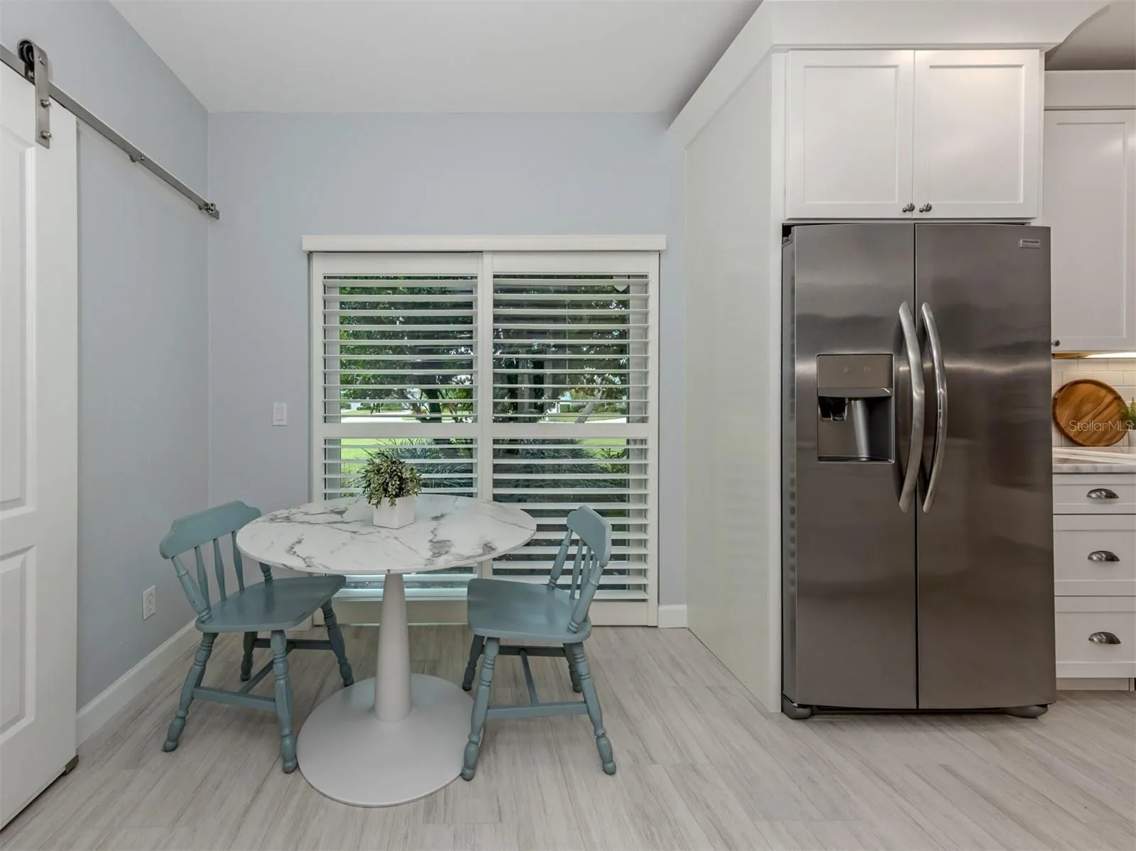 The eat in space features a sliding glass door that leads to a side patio perfect for grilling