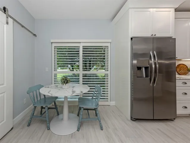 The eat in space features a sliding glass door that leads to a side patio perfect for grilling