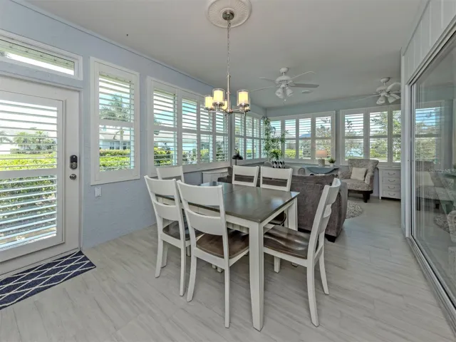 The Florida room is so bright and includes both dining space and a relaxation space