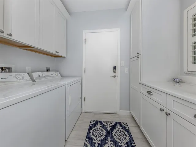 The laundry room includes plenty of extra storage and folding space