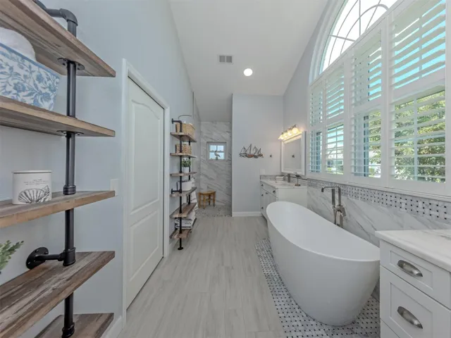 The primary bathroom features a garden tub, walk in shower, and private water closet
