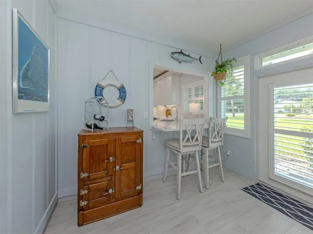 The Florida room opens to the side of the yard and is very bright