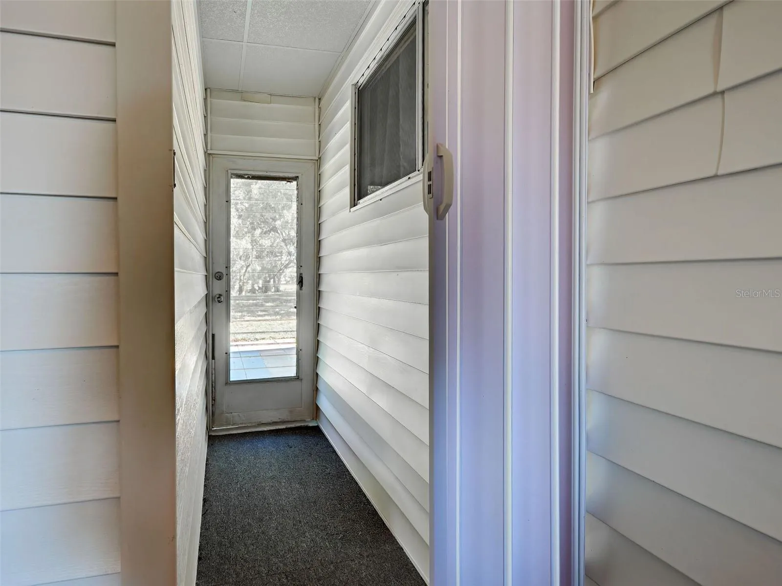 Door Leading to Back Yard from Front entry Off Carport