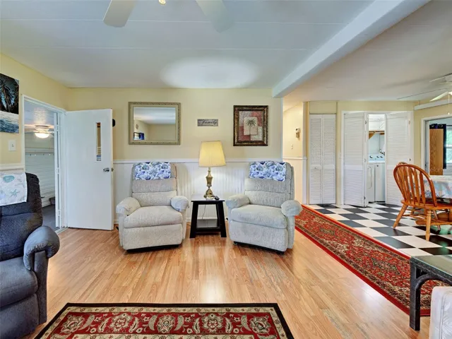 Door from front lanai entry into living room, looking into dining room