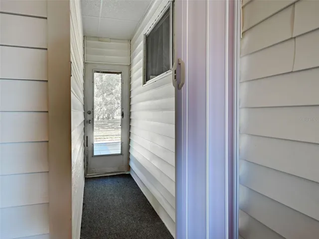 Door Leading to Back Yard from Front entry Off Carport