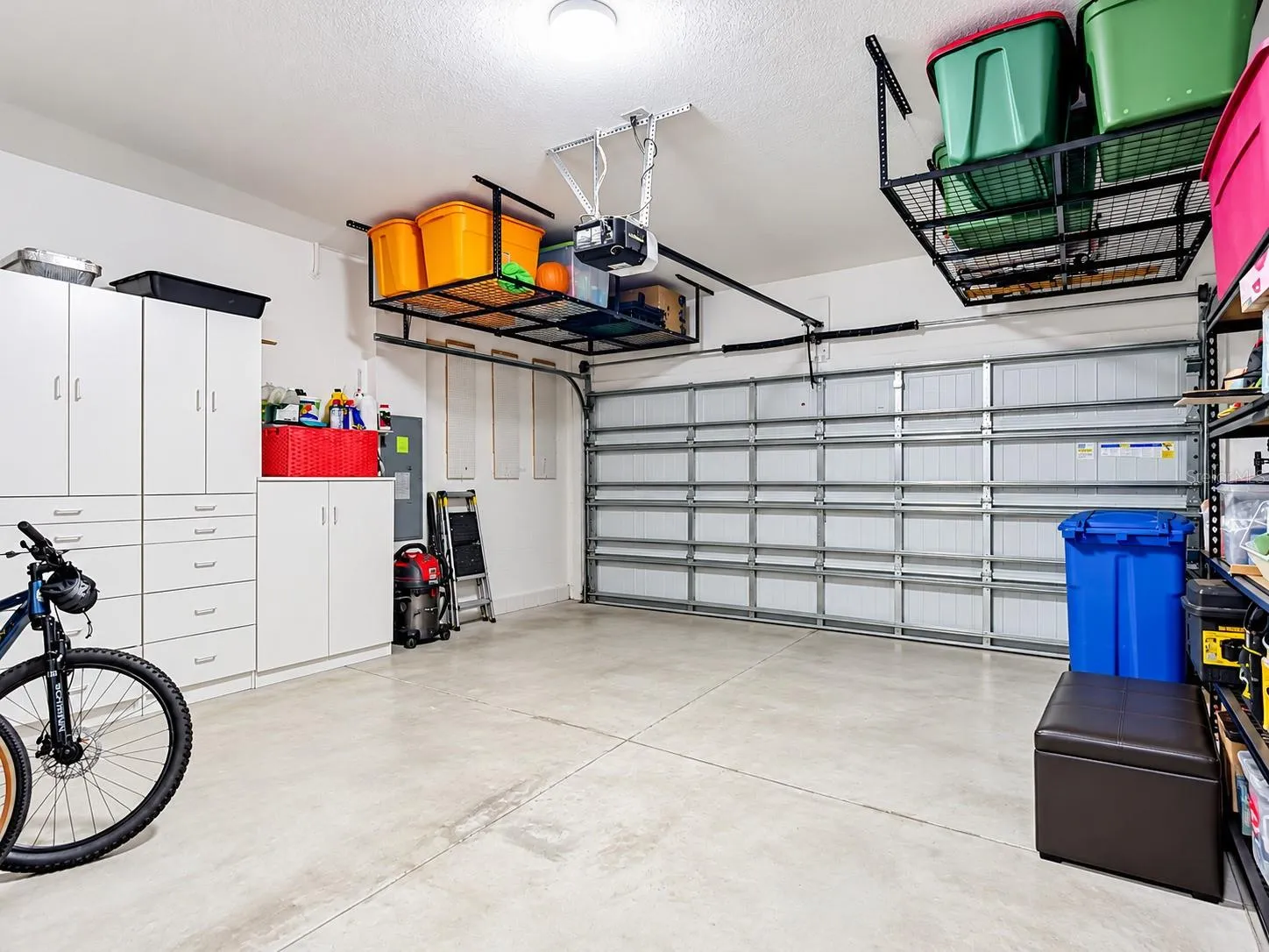 Garage with Overhead Storage and Cabinets
