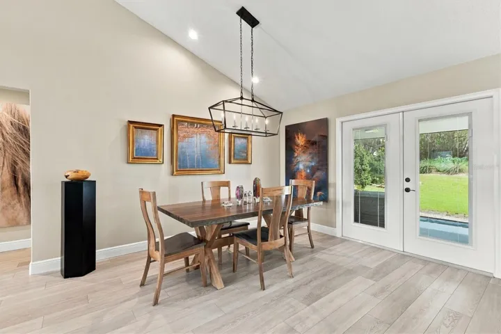 LOVELY DINING AREA WITH ENTRANCE TO SCREENED PATIO