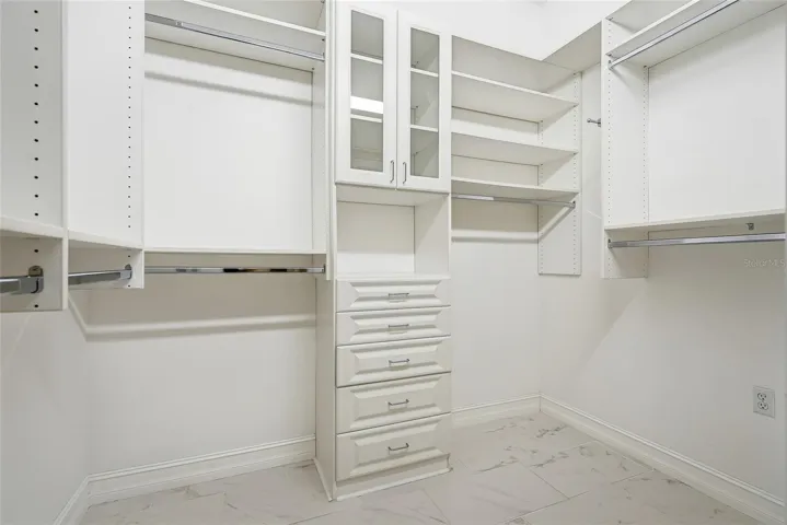 Wow! The primary walk-in closet is stunning with amazing custom shelving.