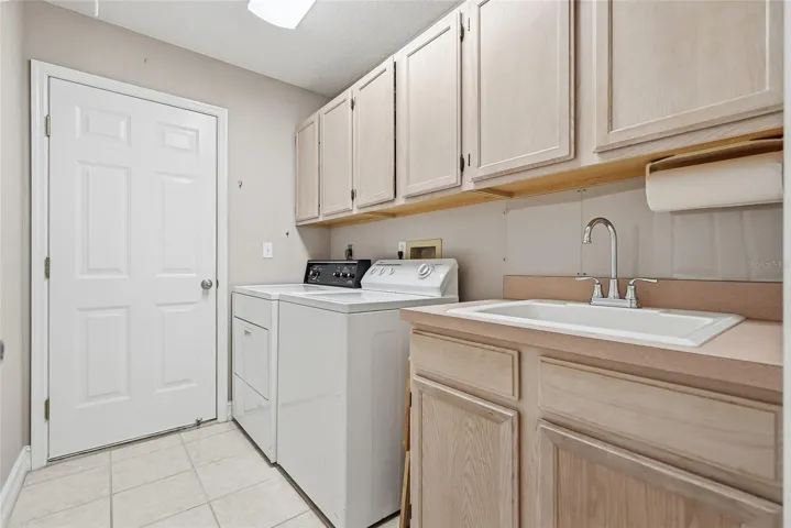 Interior laundry room with utility sink.