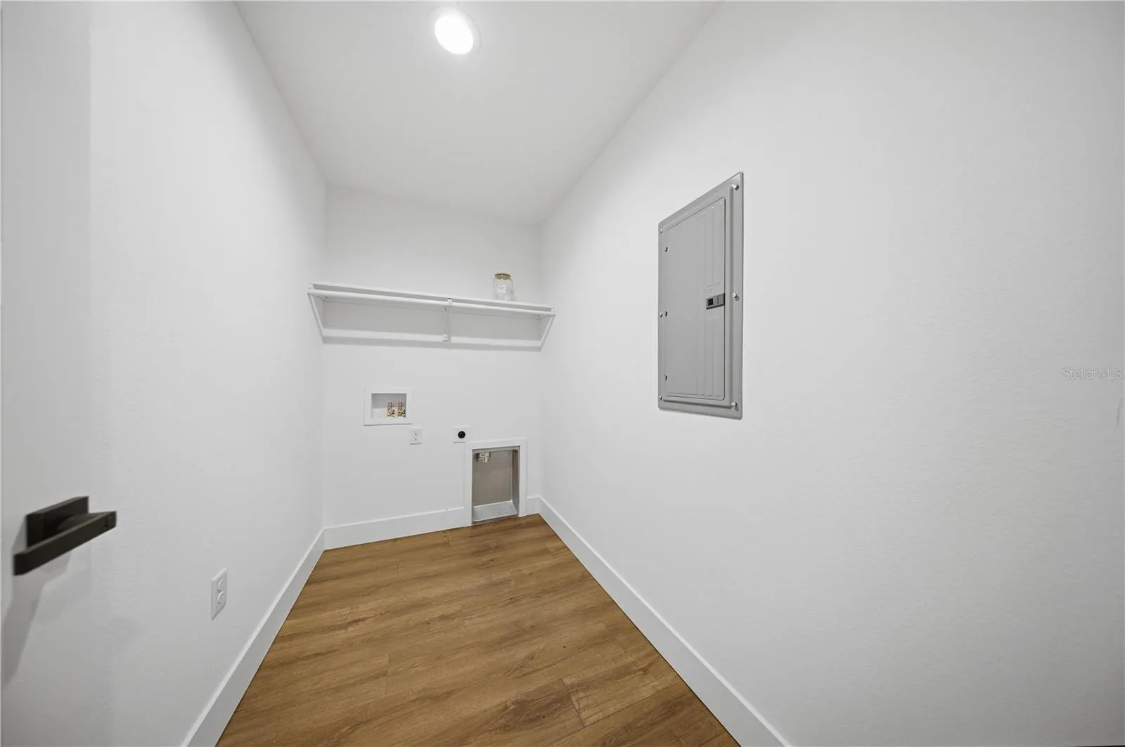 Indoor laundry room with electrical panel