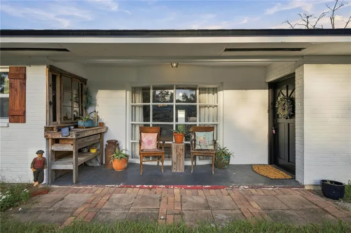 Front porch with bay window. Additional entrance on left behind wooden fixture (currently sealed)