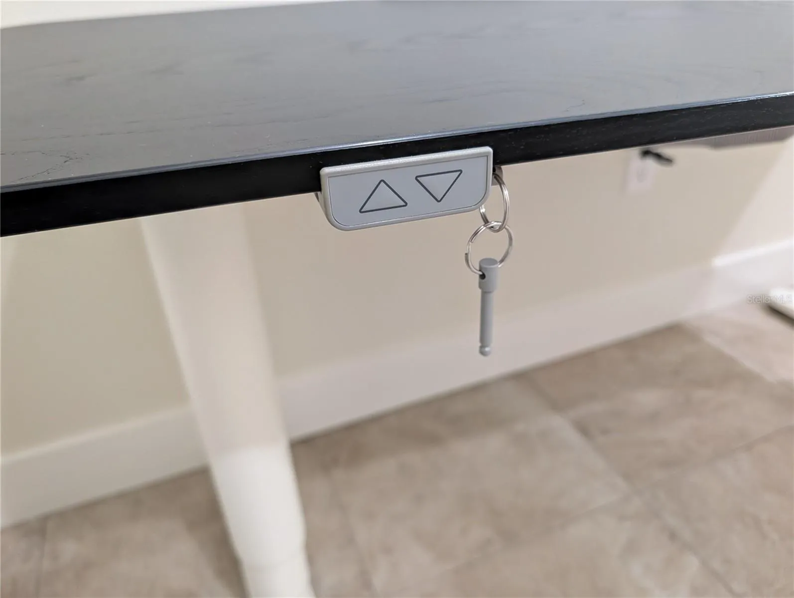 Desk lifts and has cord pockets underneath.