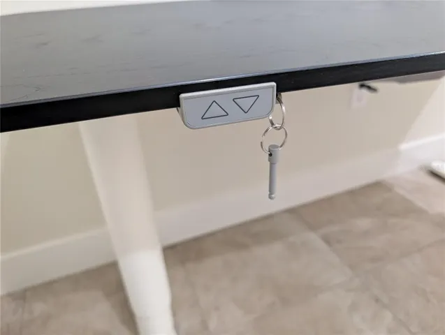 Desk lifts and has cord pockets underneath.