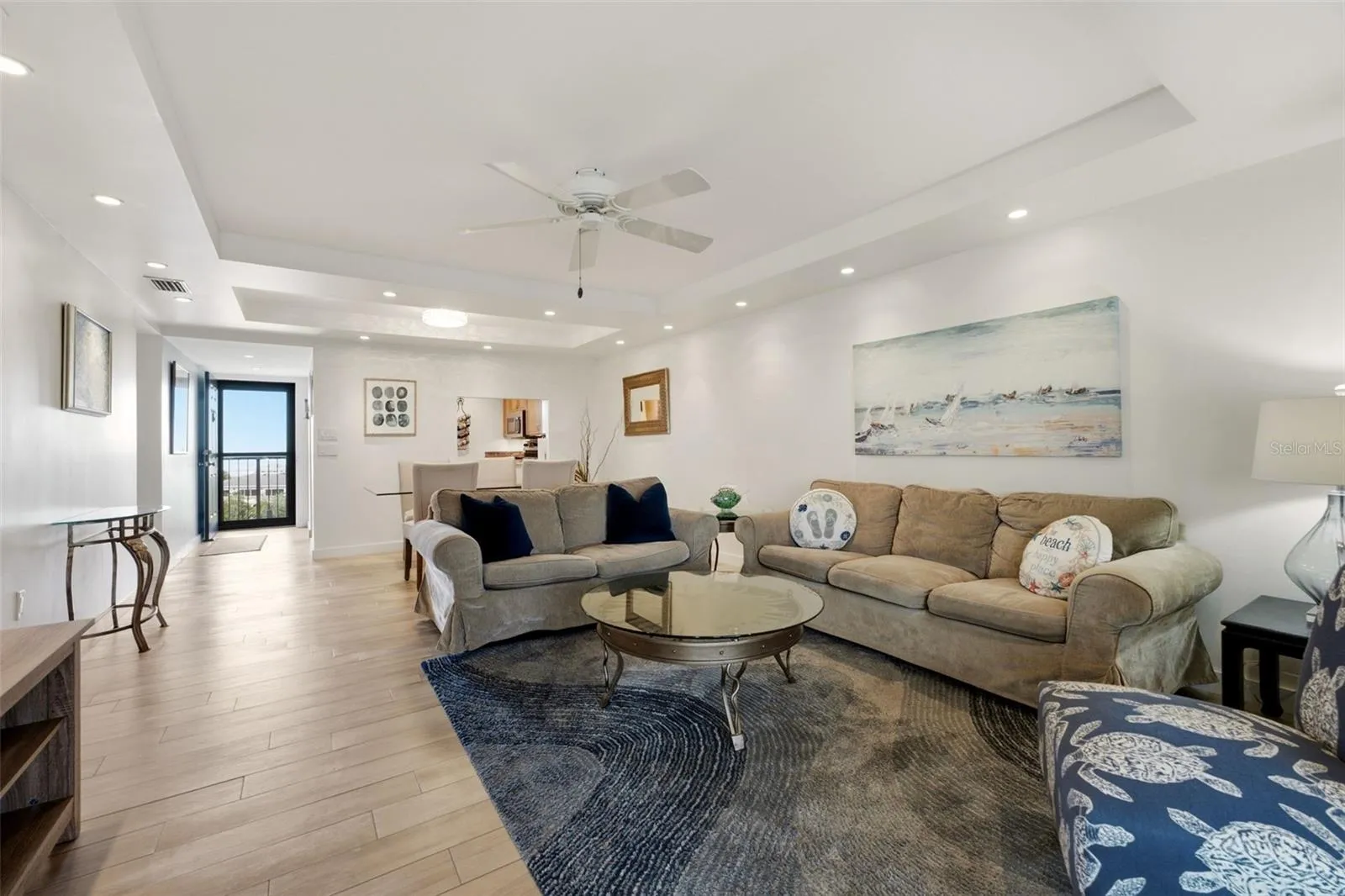 Open living and dining area with a seamless flow to the balcony and  lanai.