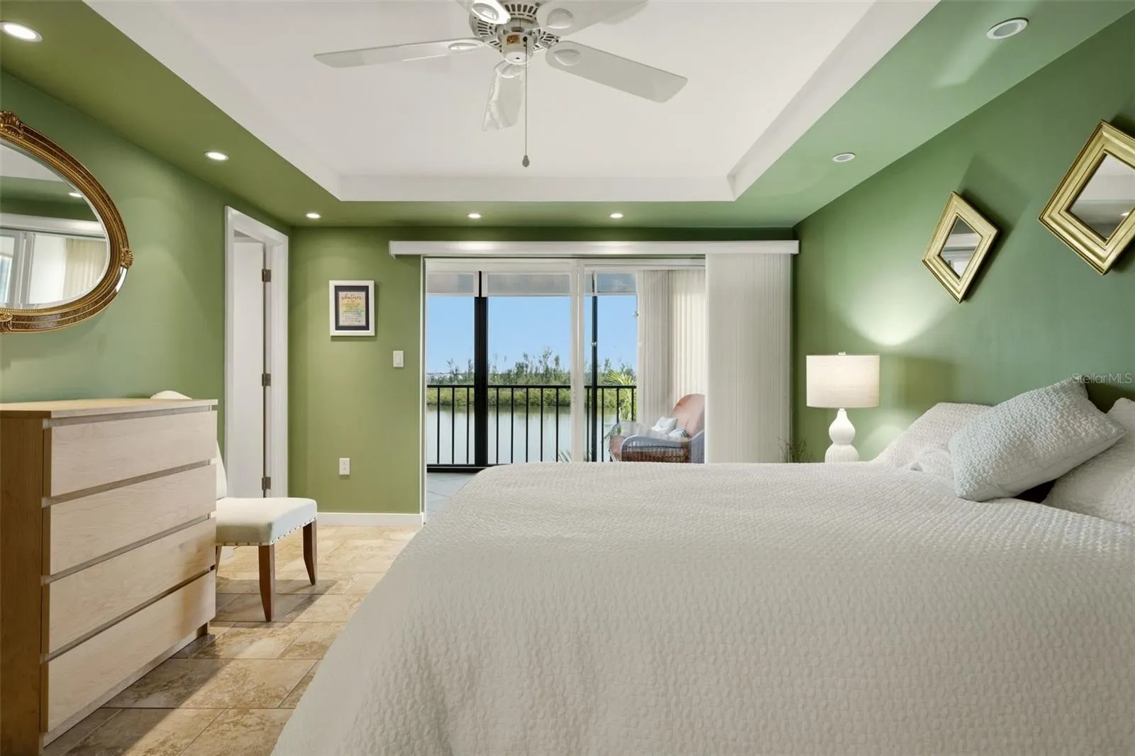 Spacious primary bedroom with coastal views and natural light