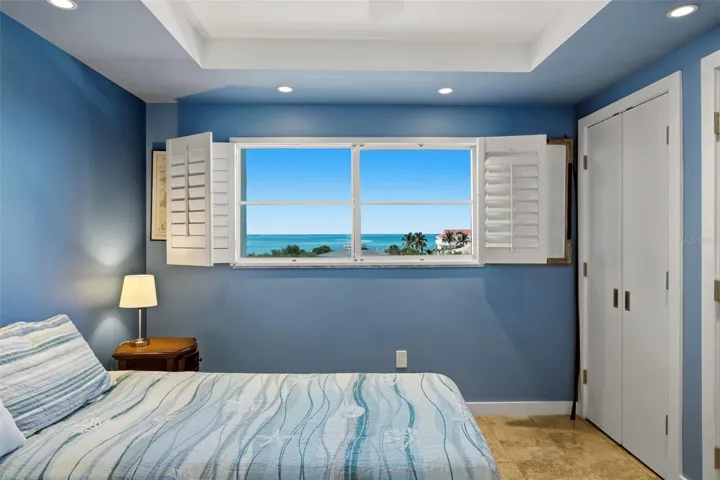 Bright guest bedroom with a peaceful coastal outlook.