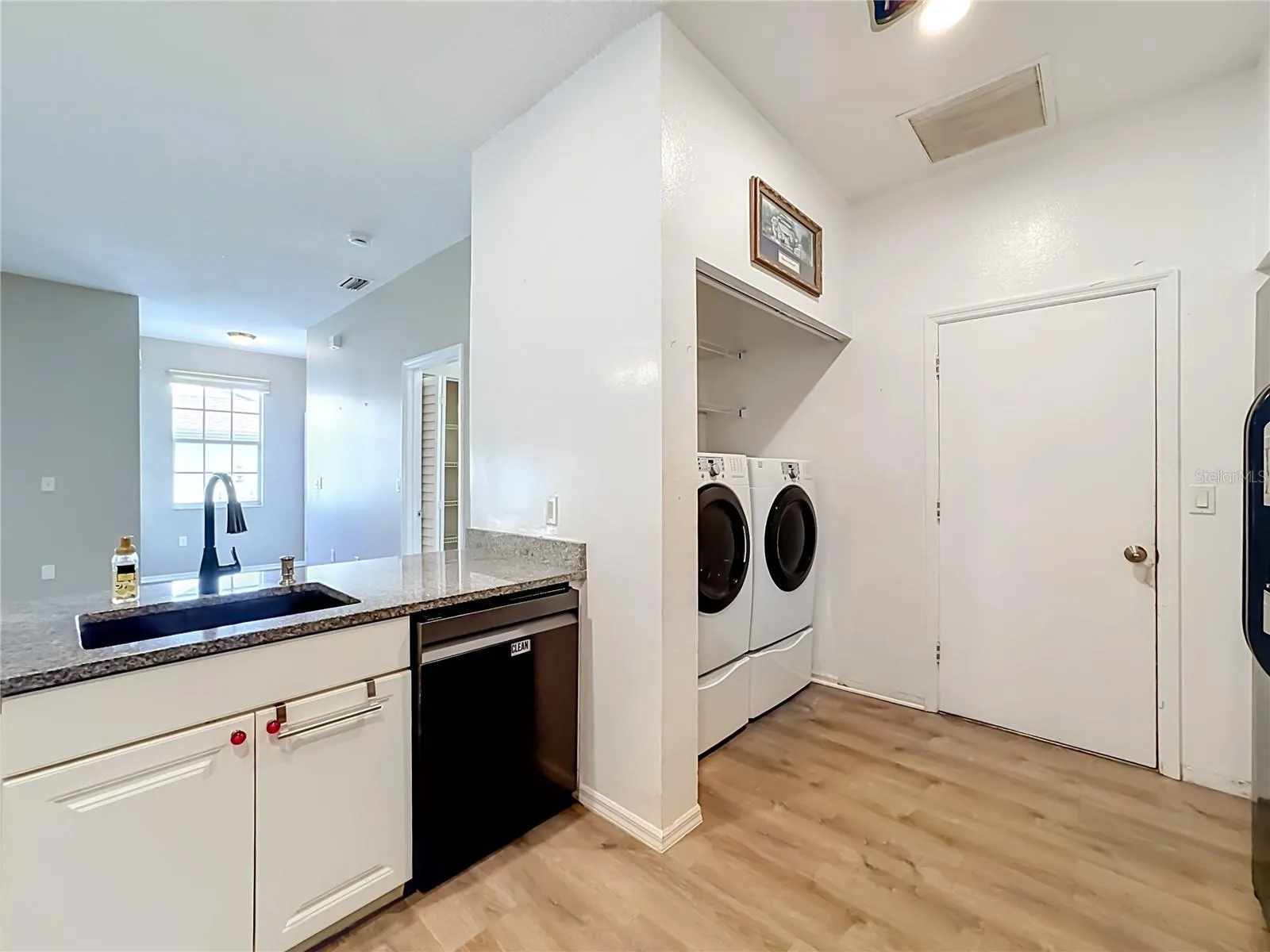 Full size front loading washer and dryer in kitchen.