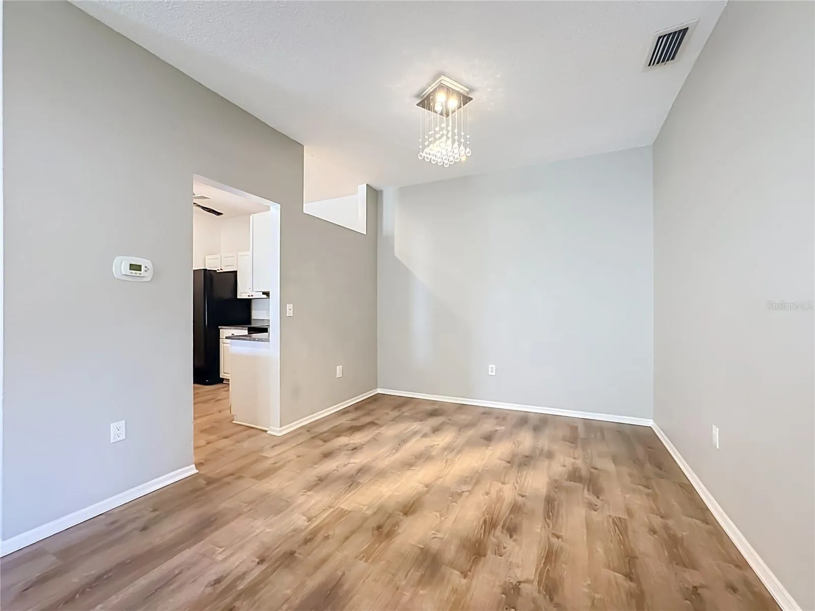 Closer view of the dining room with kitchen entrance to the left.