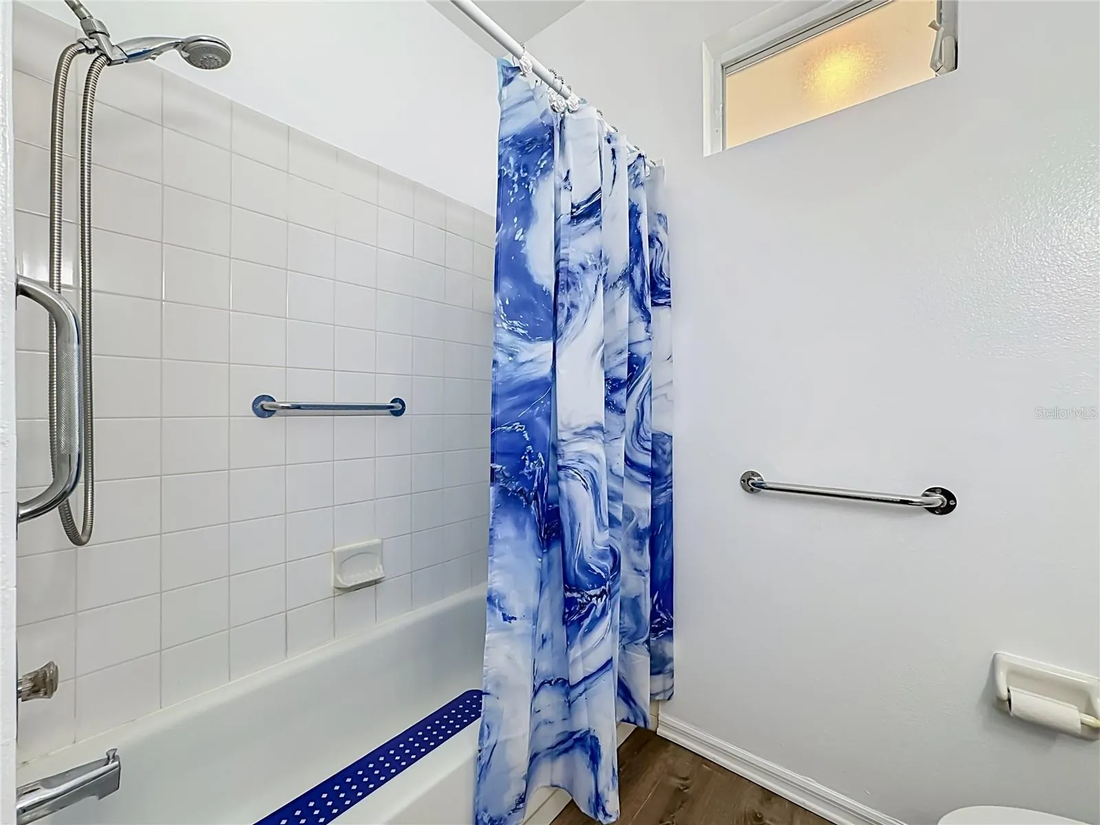 Guest tub and shower combination with the comfort or a grab bar.