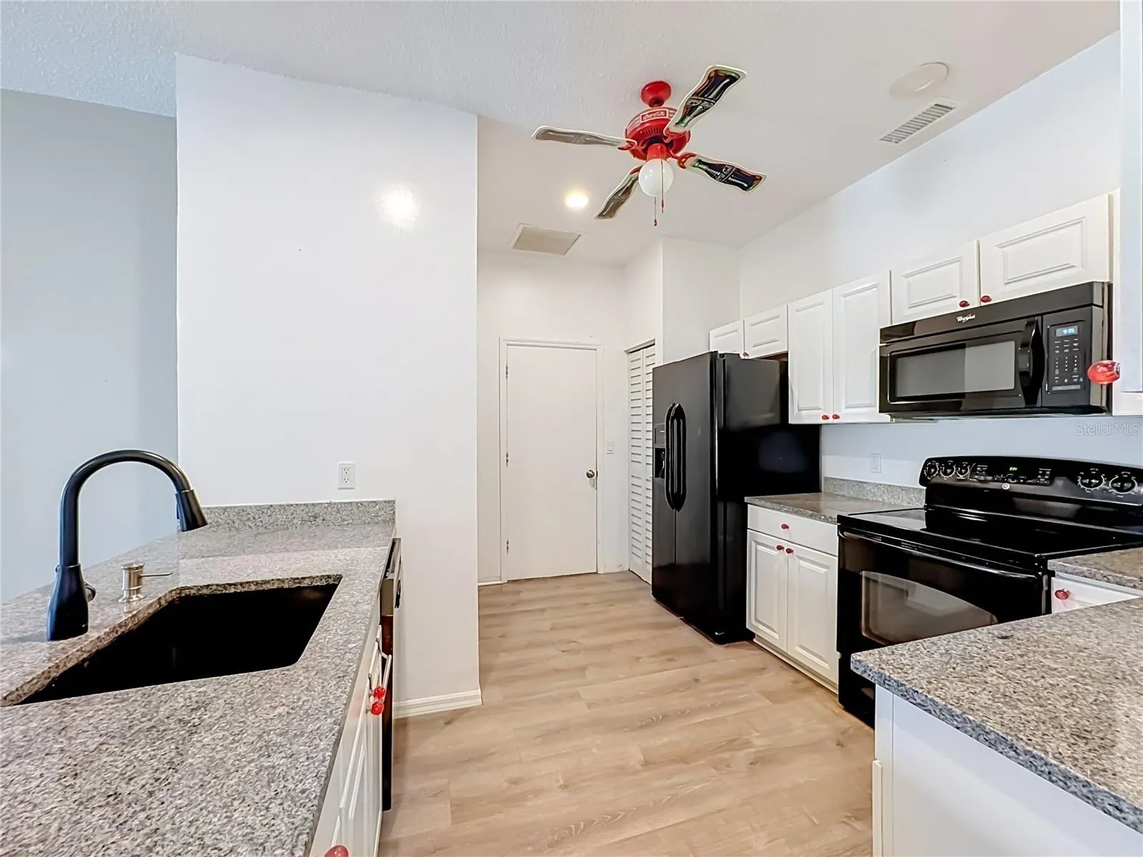 Kitchen features granite counters, upgraded sink and faucet.