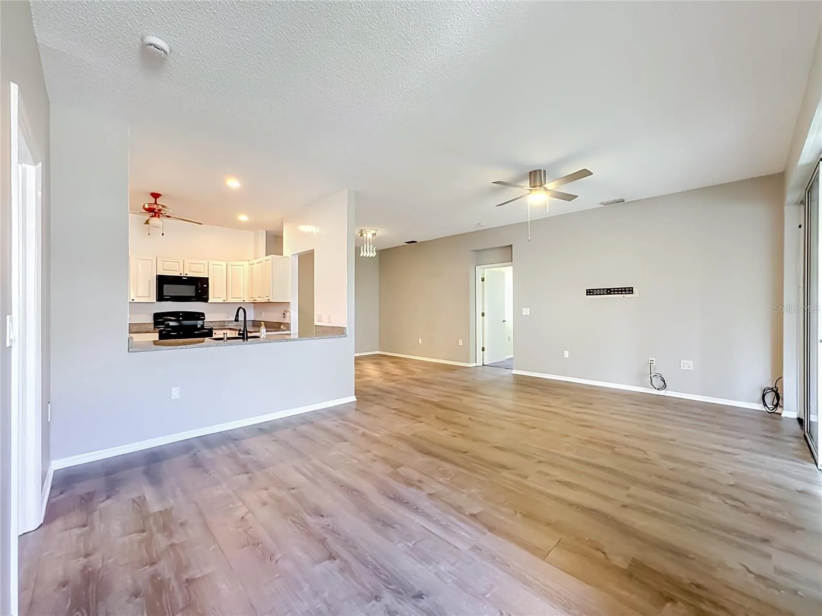 Great room with kitchen and dining room to the left.