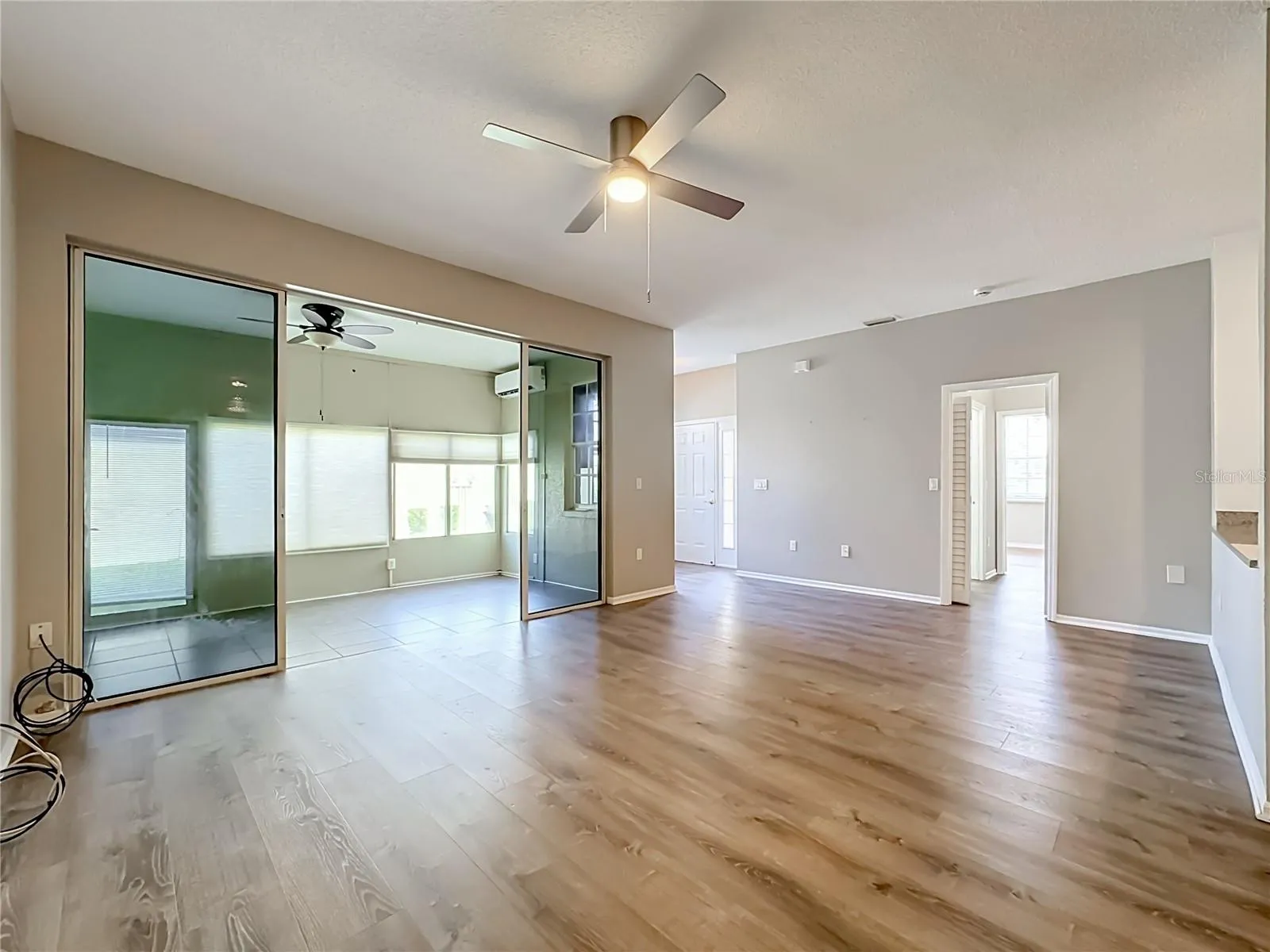 Great room with sliding door to the separately air conditioned large (280 sq. ft.) Florida room.