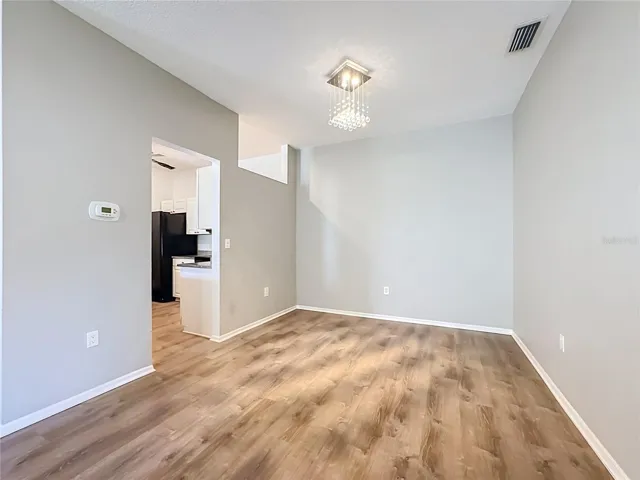 Closer view of the dining room with kitchen entrance to the left.