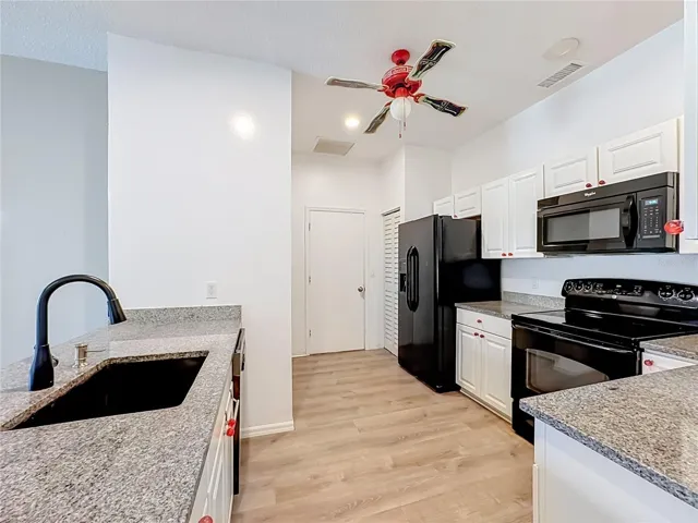 Kitchen features granite counters, upgraded sink and faucet.