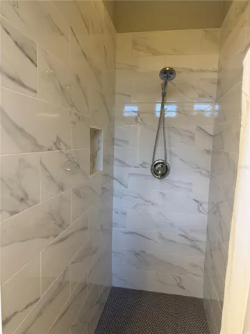 Newly renovated and never used Primary shower with shampoo niche.