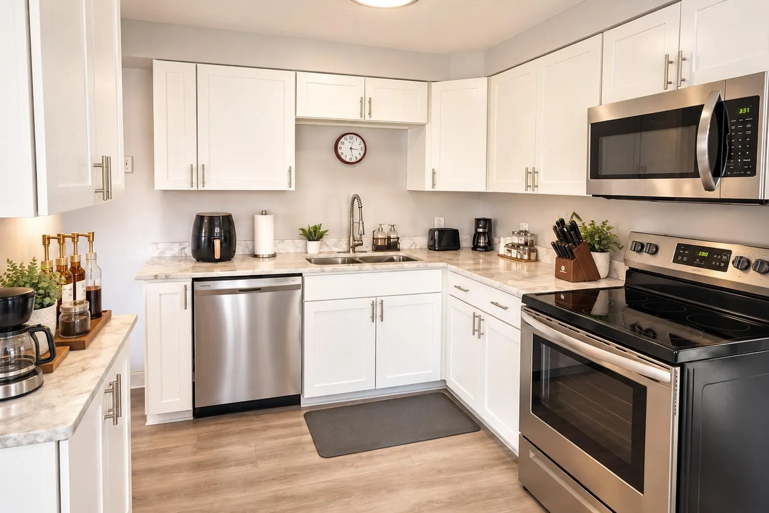 Granite countertops and backsplash complement the crisp white cabinetry.