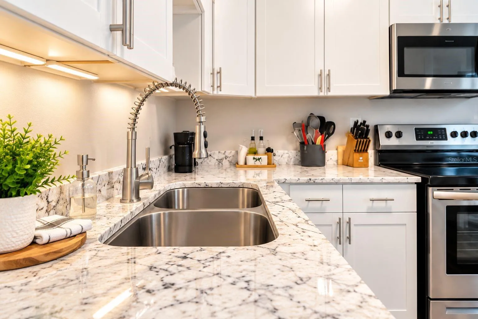 Close-up of the kitchen’s granite surfaces and updated fixtures.