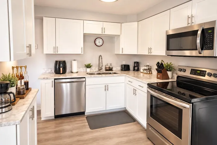 Granite countertops and backsplash complement the crisp white cabinetry.
