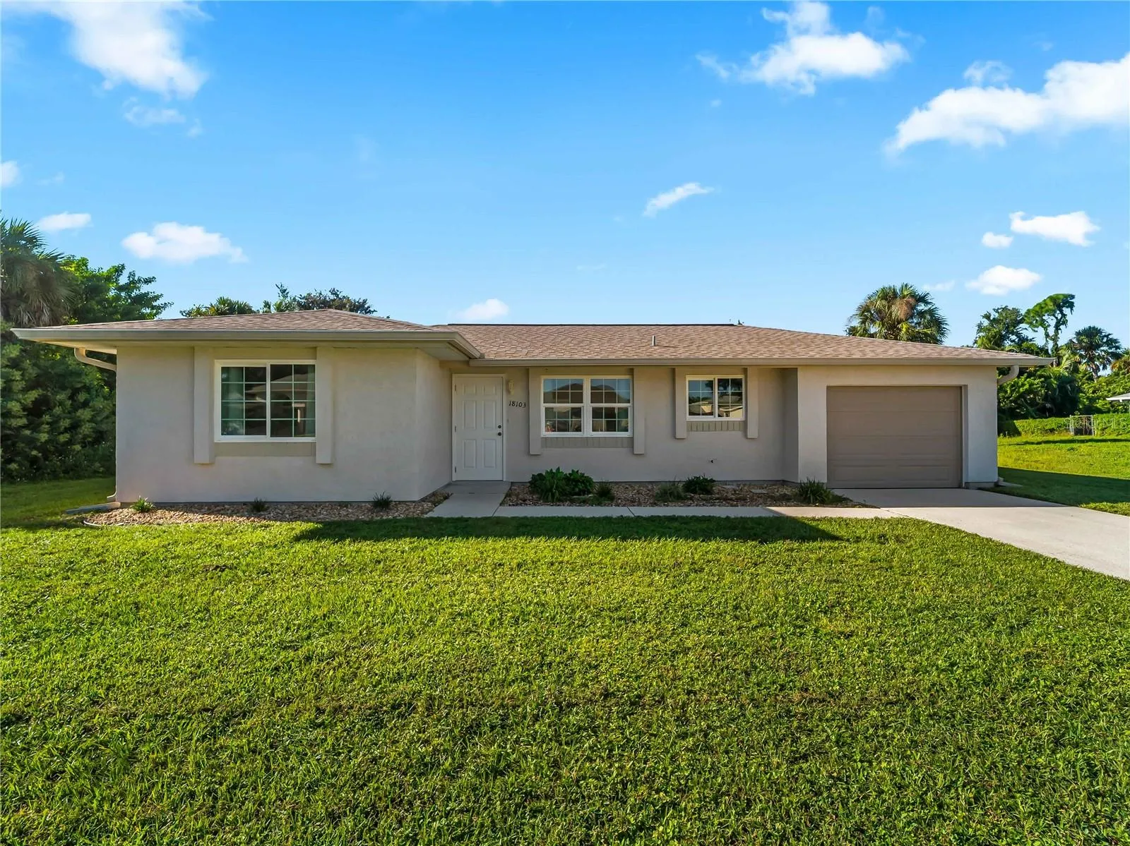 FrontExterior_18103WindsweptAvenue_PortCharlotte_SpaciousLawn_Daylight.jpg