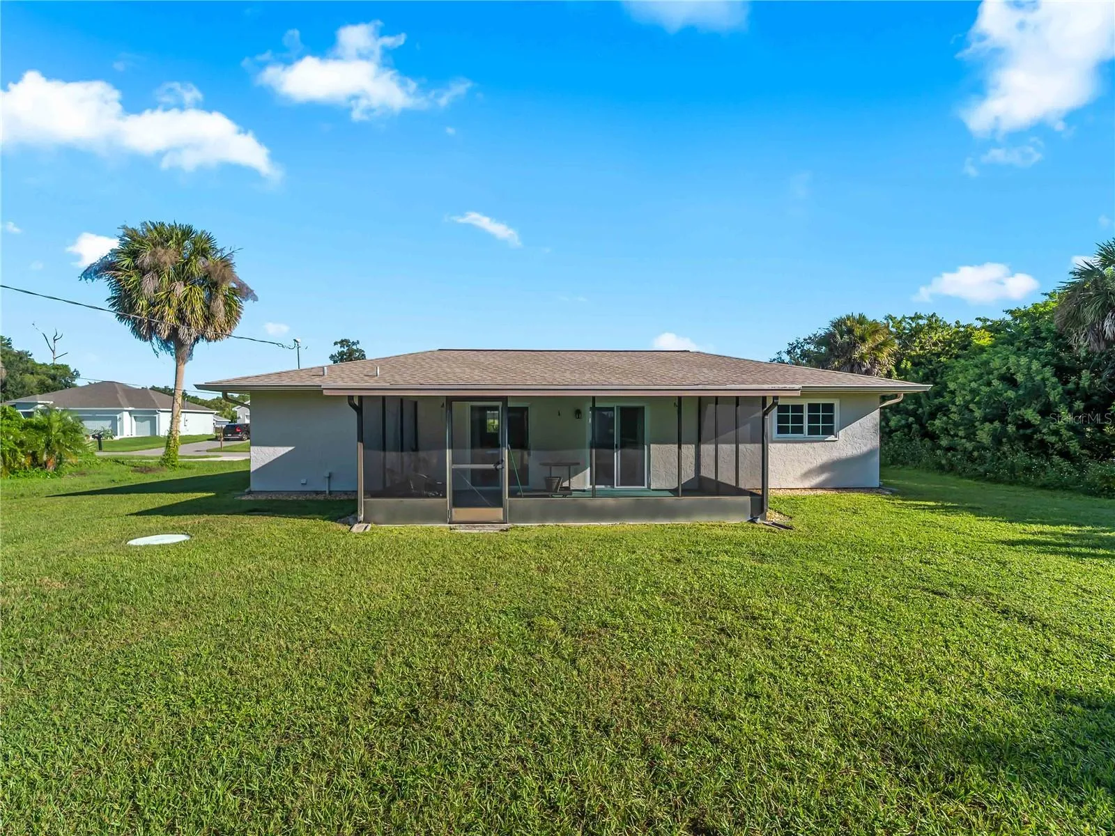 RearExterior_18103WindsweptAvenue_PortCharlotte_SpaciousLawn_Daylight.jpg